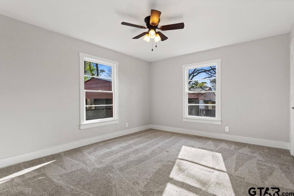 2819 New Copeland Road Tyler, TX 75701 - Photo 24 of 39 an empty room with windows and ceiling fan
