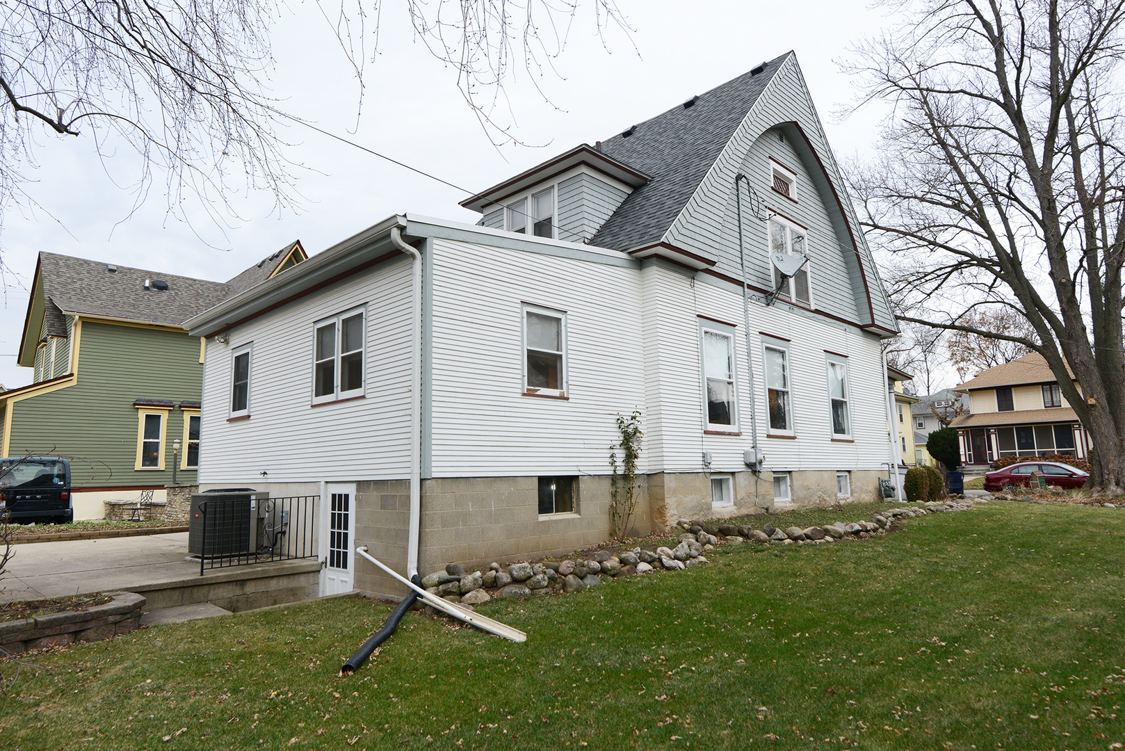 564 North Spring Street Elgin, IL 60120 - Photo 26 of 27 a view of a white house with a big yard and large tree