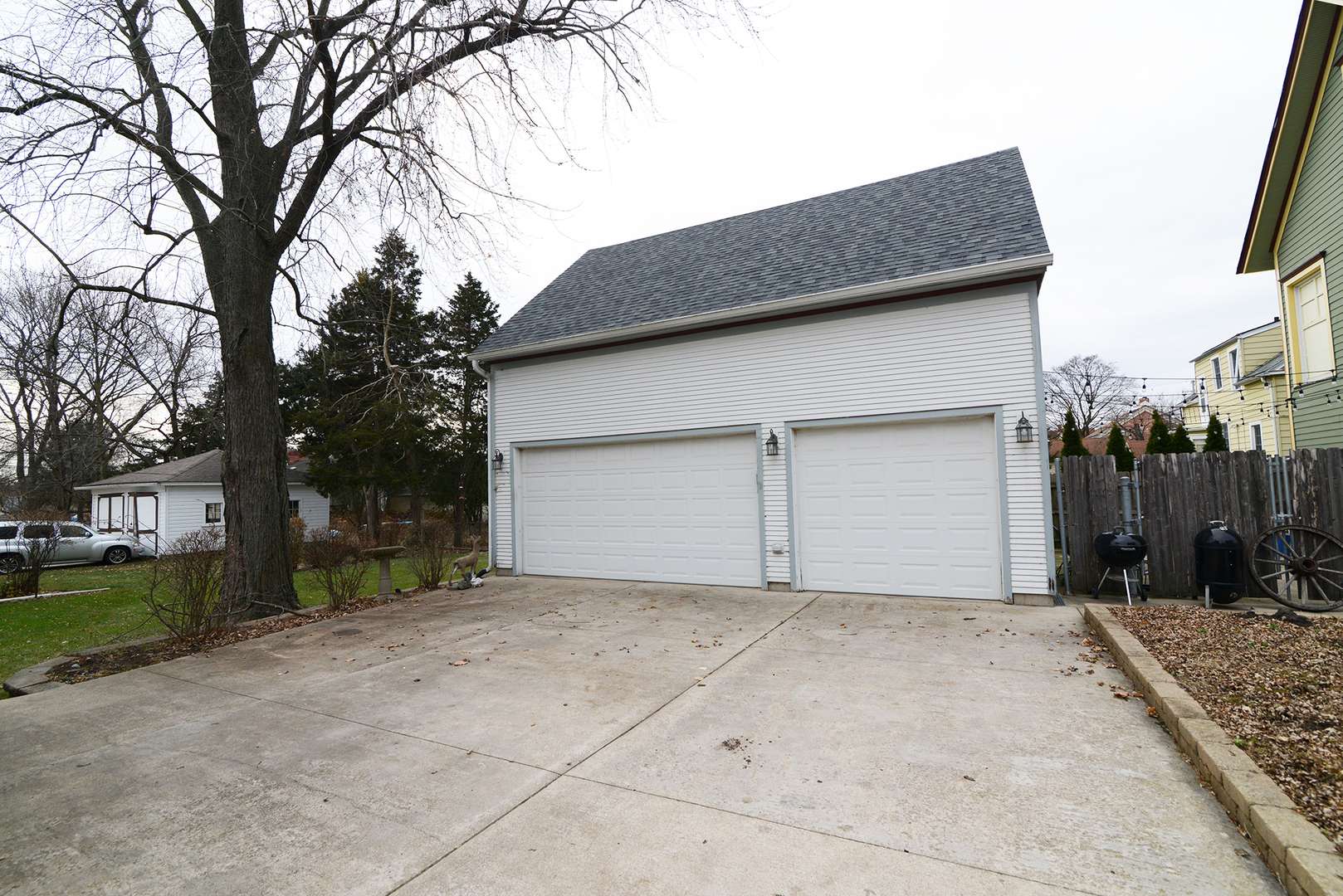 564 North Spring Street Elgin, IL 60120 - Photo 3 of 27 a backyard of a house with garage and trees
