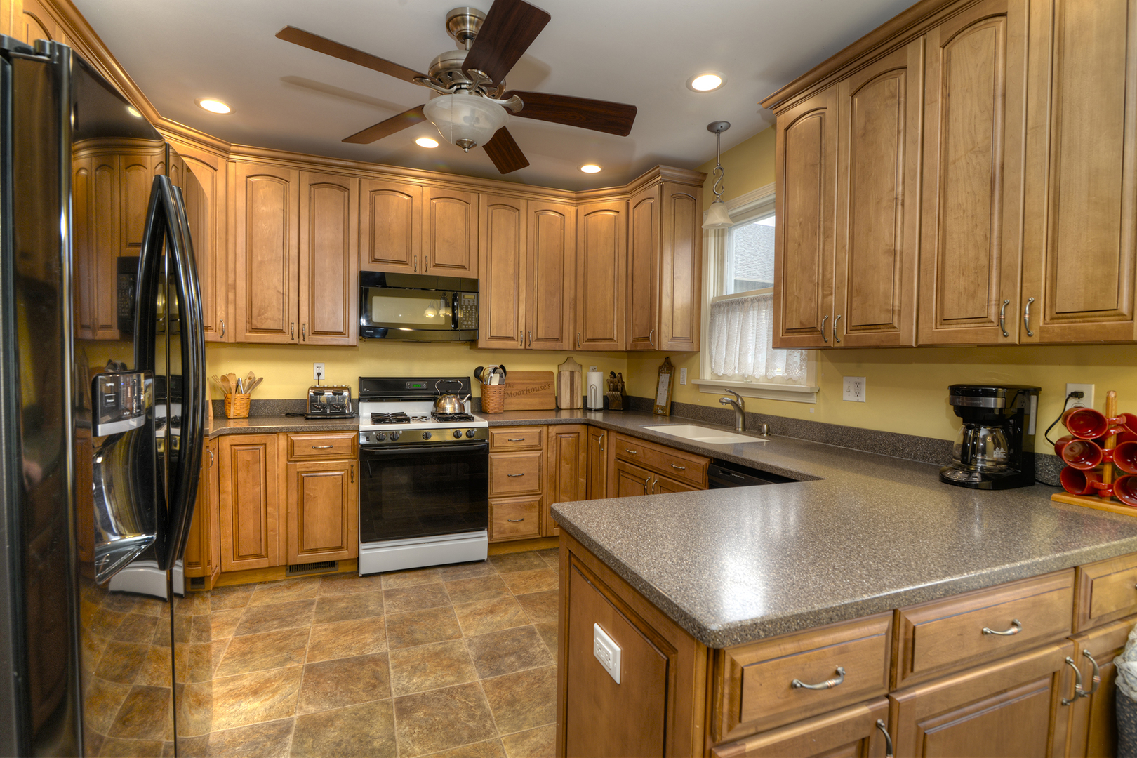 564 North Spring Street Elgin, IL 60120 - Photo 9 of 27 a kitchen with a stove a refrigerator and a sink