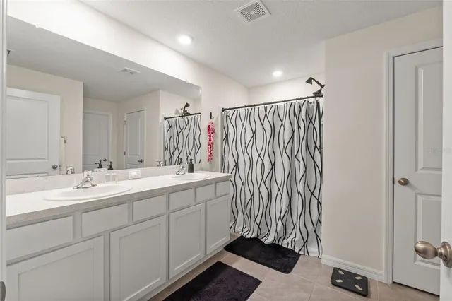 a bathroom with a double vanity sink and mirror