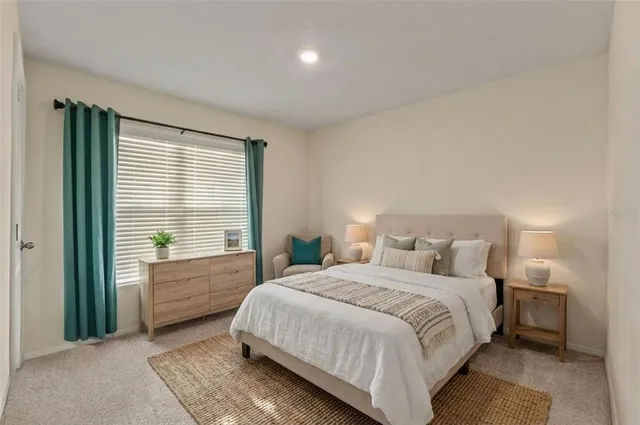 a spacious bedroom with a bed and a window