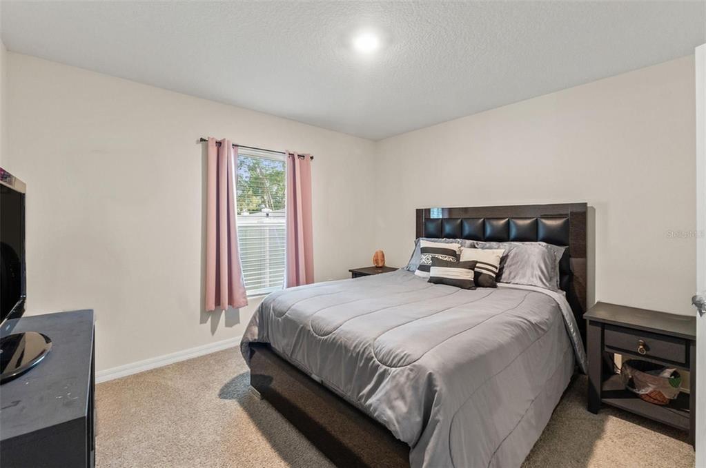 2448 Dothan Avenue Spring Hill, FL 34609 - Photo 13 of 20 a bedroom with a bed and a flat screen tv