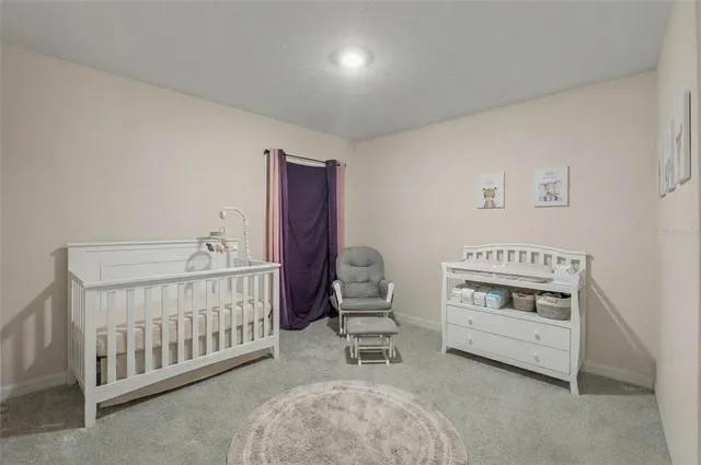 a bedroom with furniture and baby crib