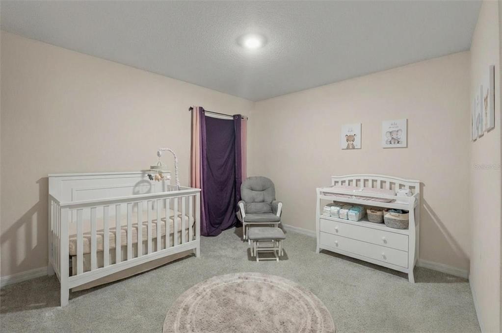 2448 Dothan Avenue Spring Hill, FL 34609 - Photo 15 of 20 a bedroom with furniture and baby crib