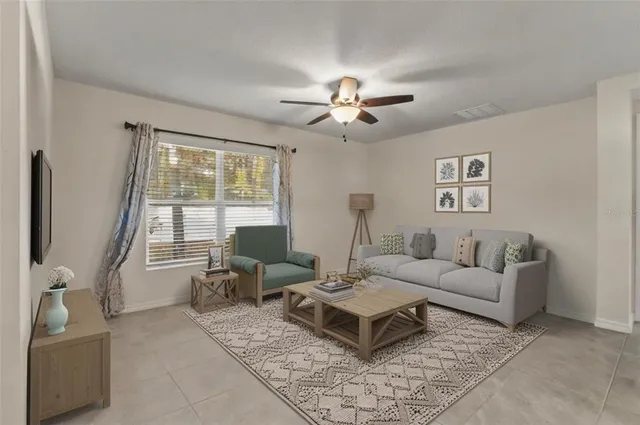 a living room with furniture a chandelier and a window