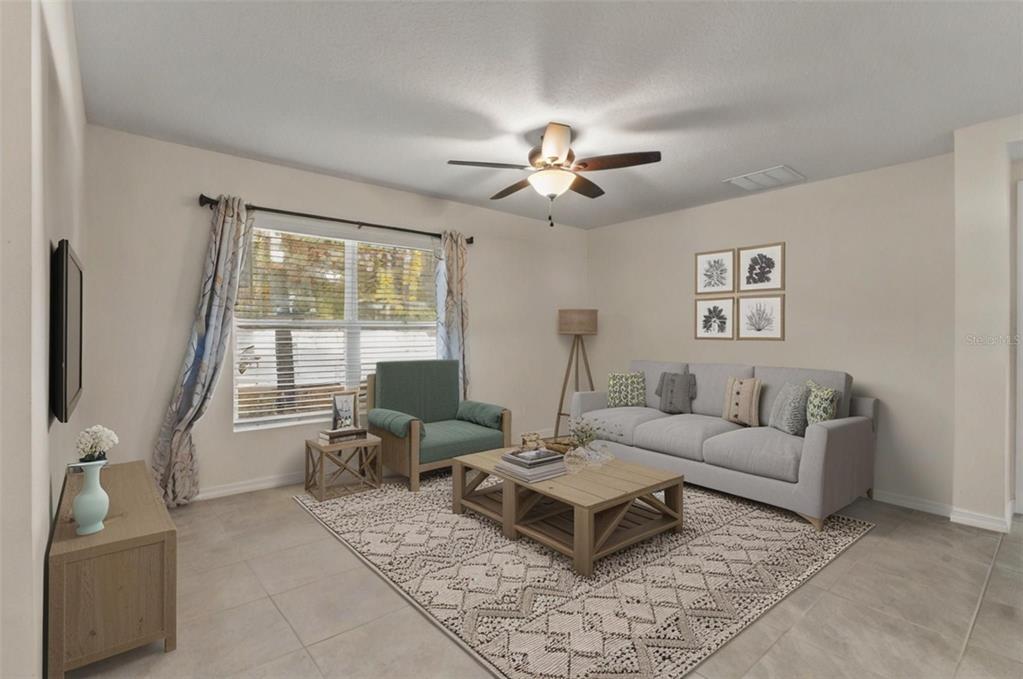 2448 Dothan Avenue Spring Hill, FL 34609 - Photo 9 of 20 a living room with furniture a chandelier and a window