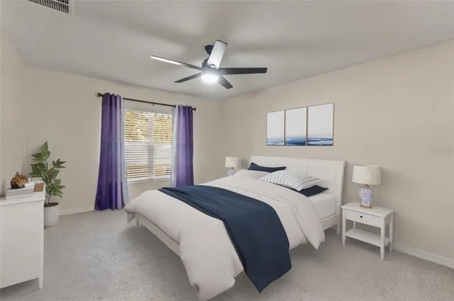 a bedroom with a large bed and a chandelier