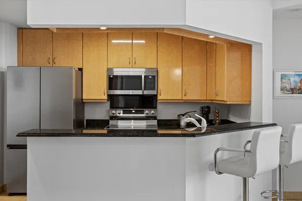a kitchen with stainless steel appliances a sink a stove and a refrigerator