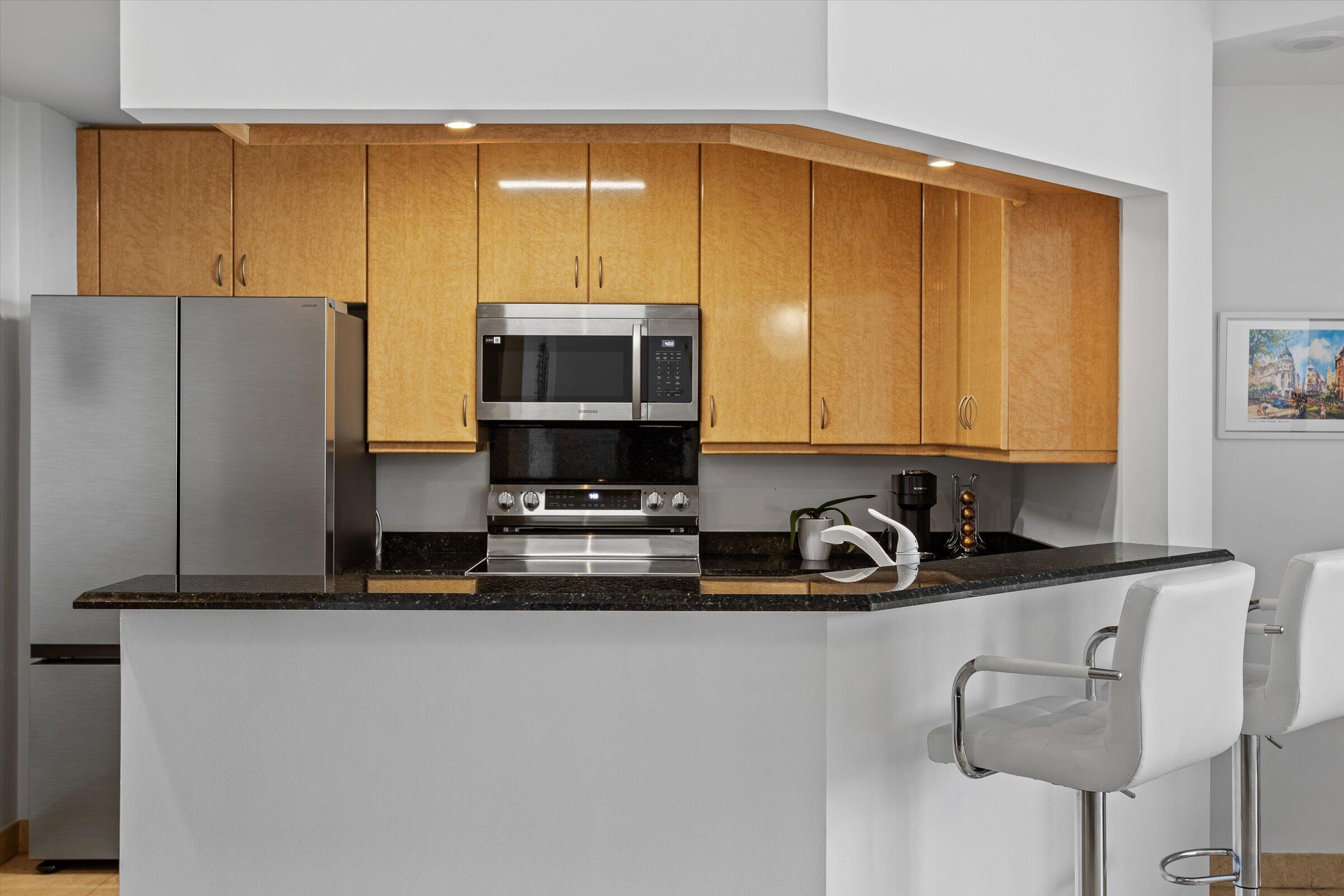801 Brickell Key Boulevard, Unit 2805 Miami, FL 33131 - Photo 12 of 42 a kitchen with stainless steel appliances a sink a stove and a refrigerator