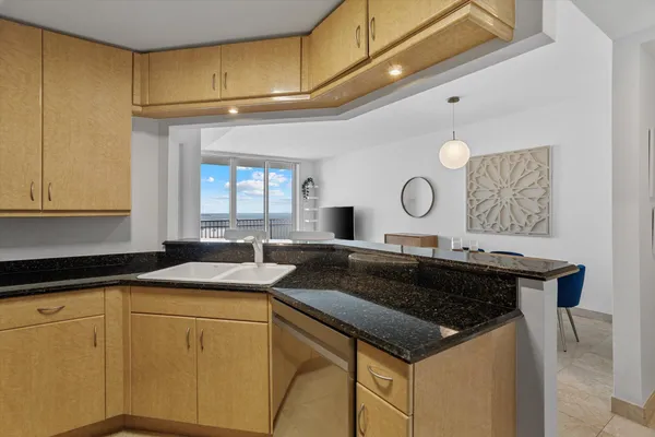 a kitchen with a sink a stove and cabinets
