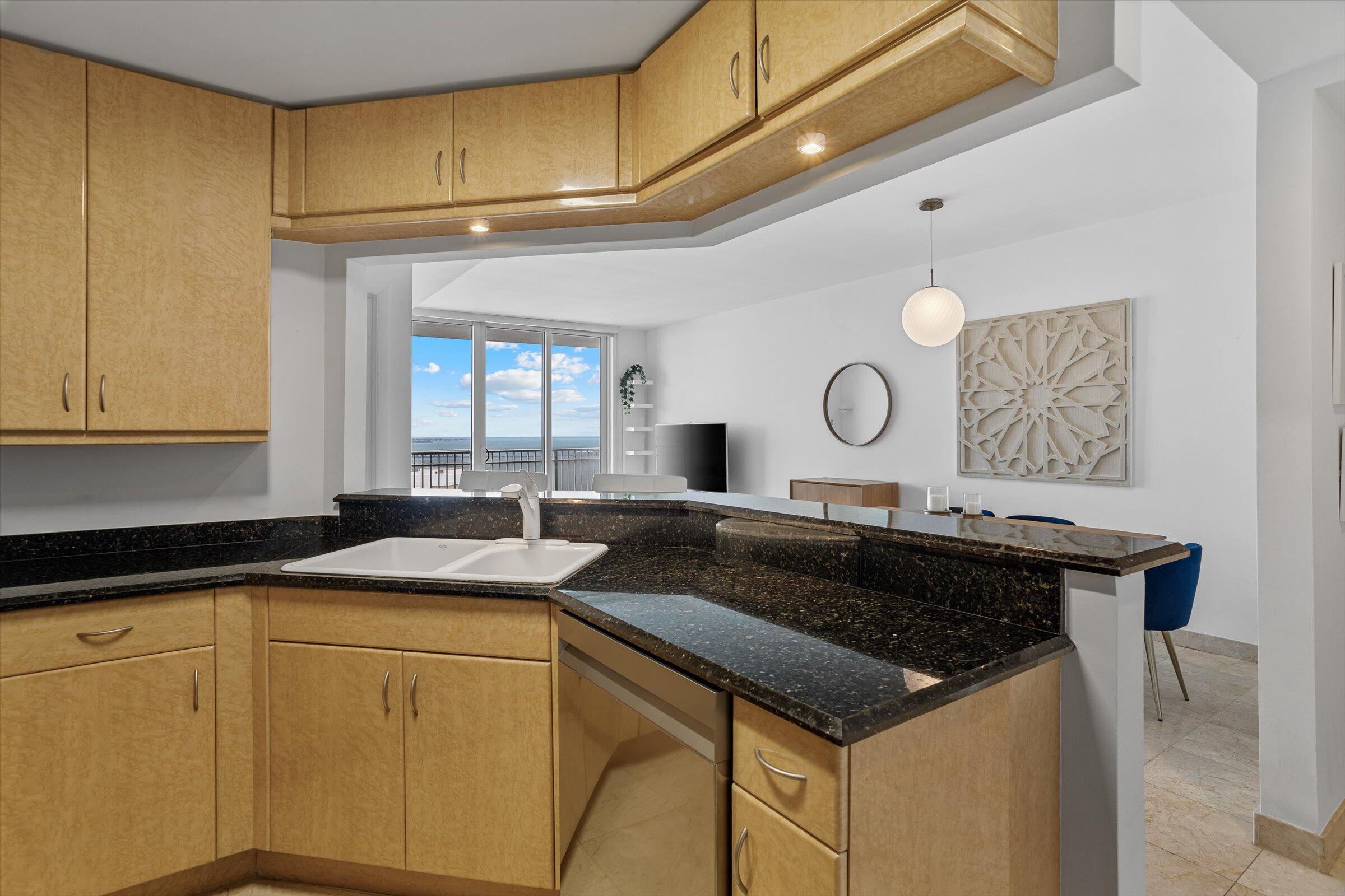 801 Brickell Key Boulevard, Unit 2805 Miami, FL 33131 - Photo 14 of 42 a kitchen with a sink a stove and cabinets
