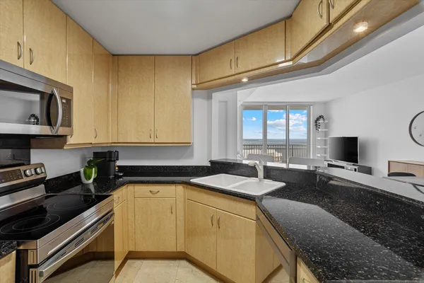 a kitchen with a stove a sink and a microwave