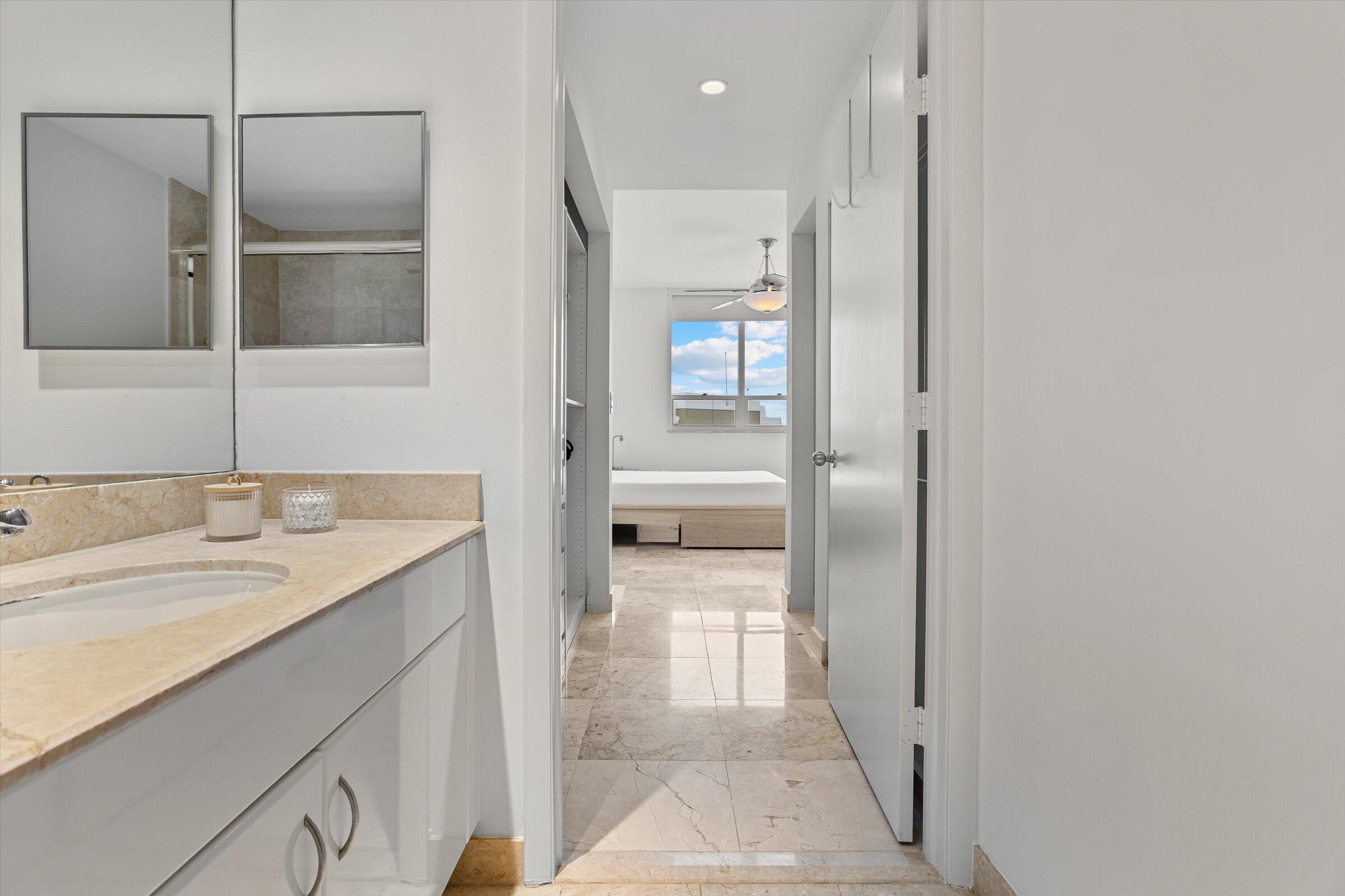 801 Brickell Key Boulevard, Unit 2805 Miami, FL 33131 - Photo 22 of 42 a bathroom with a sink a mirror and a shower
