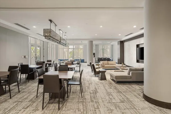 a living room with lots of furniture and a potted plant