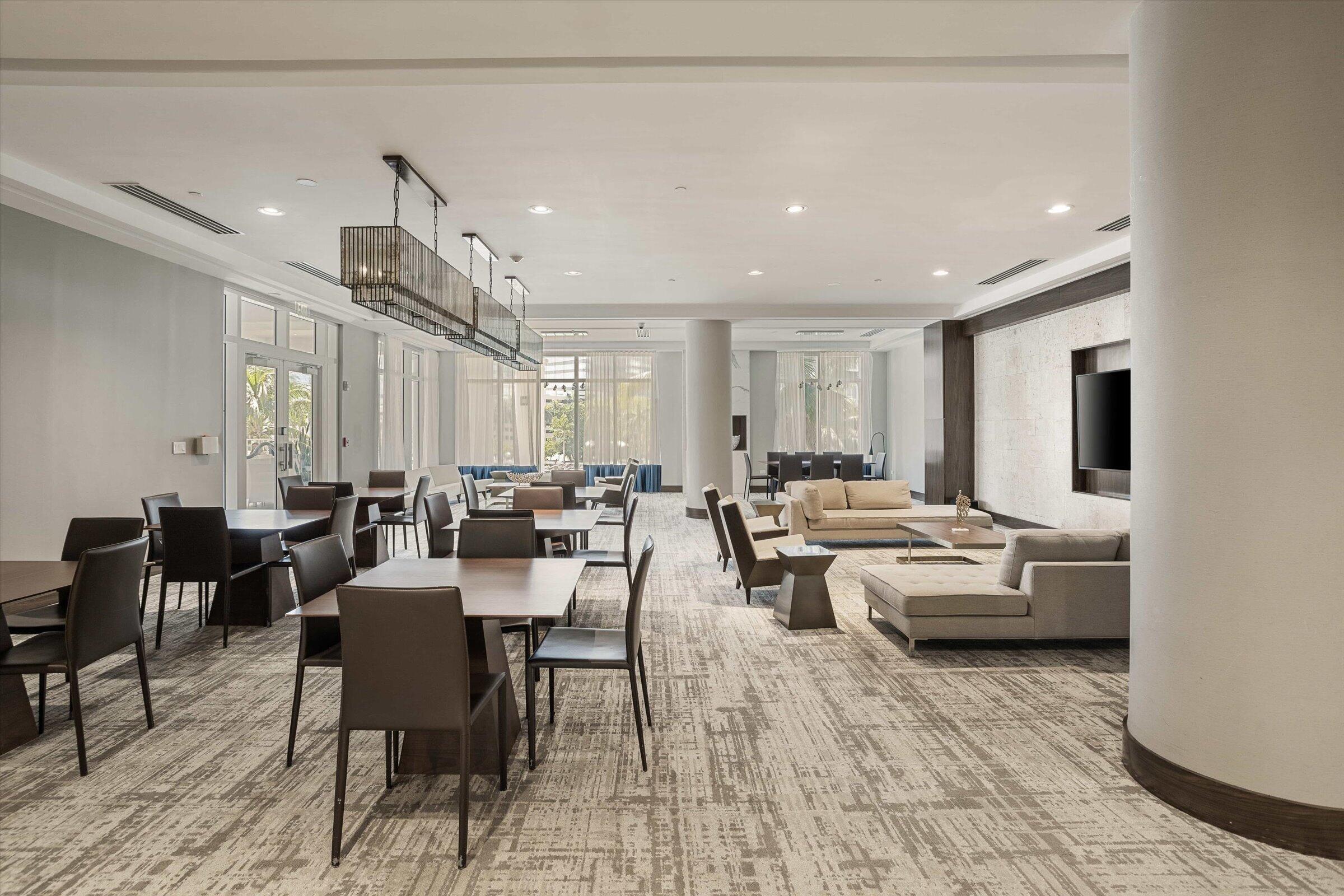 801 Brickell Key Boulevard, Unit 2805 Miami, FL 33131 - Photo 28 of 42 a living room with lots of furniture and a potted plant