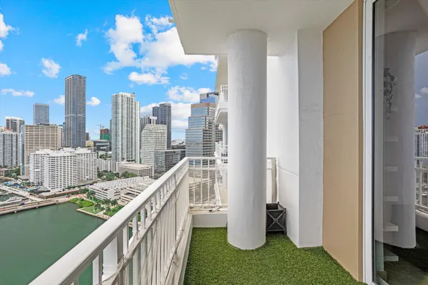 a view of a balcony with yard