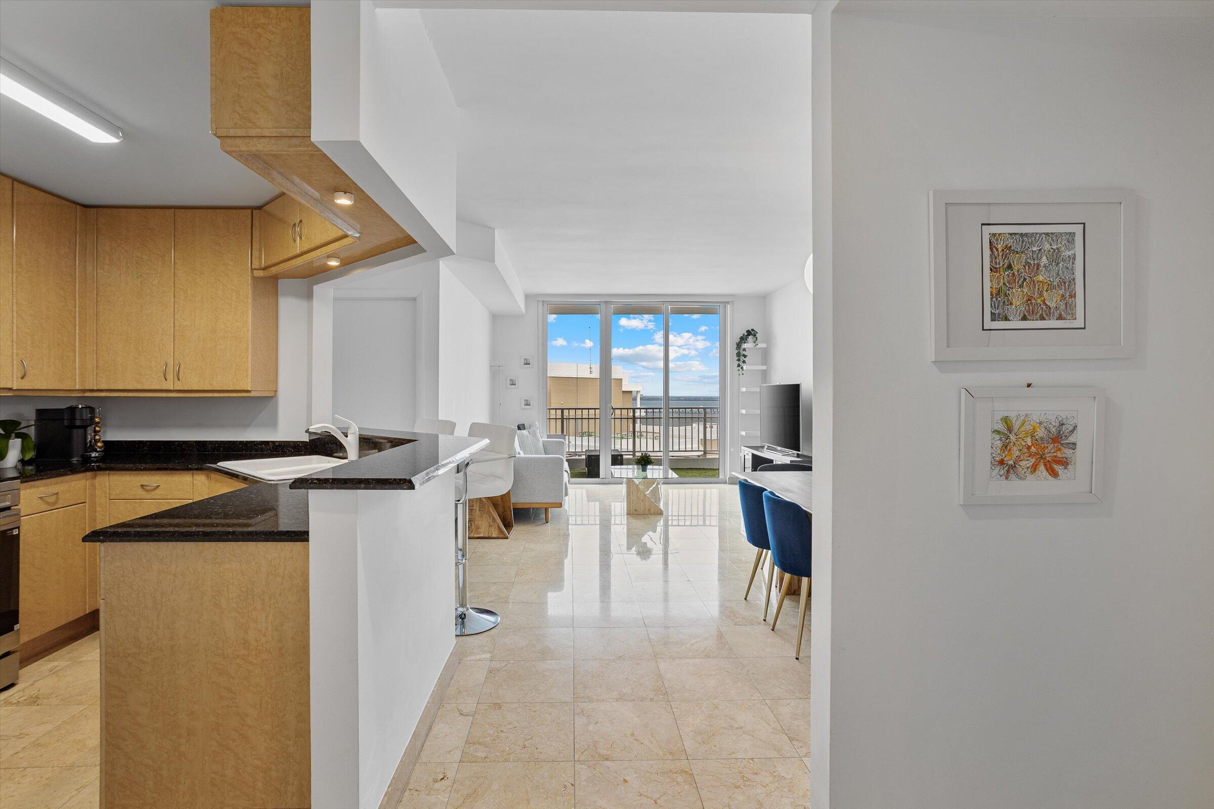 801 Brickell Key Boulevard, Unit 2805 Miami, FL 33131 - Photo 6 of 42 a view of a kitchen with kitchen island a counter top space a sink and appliances