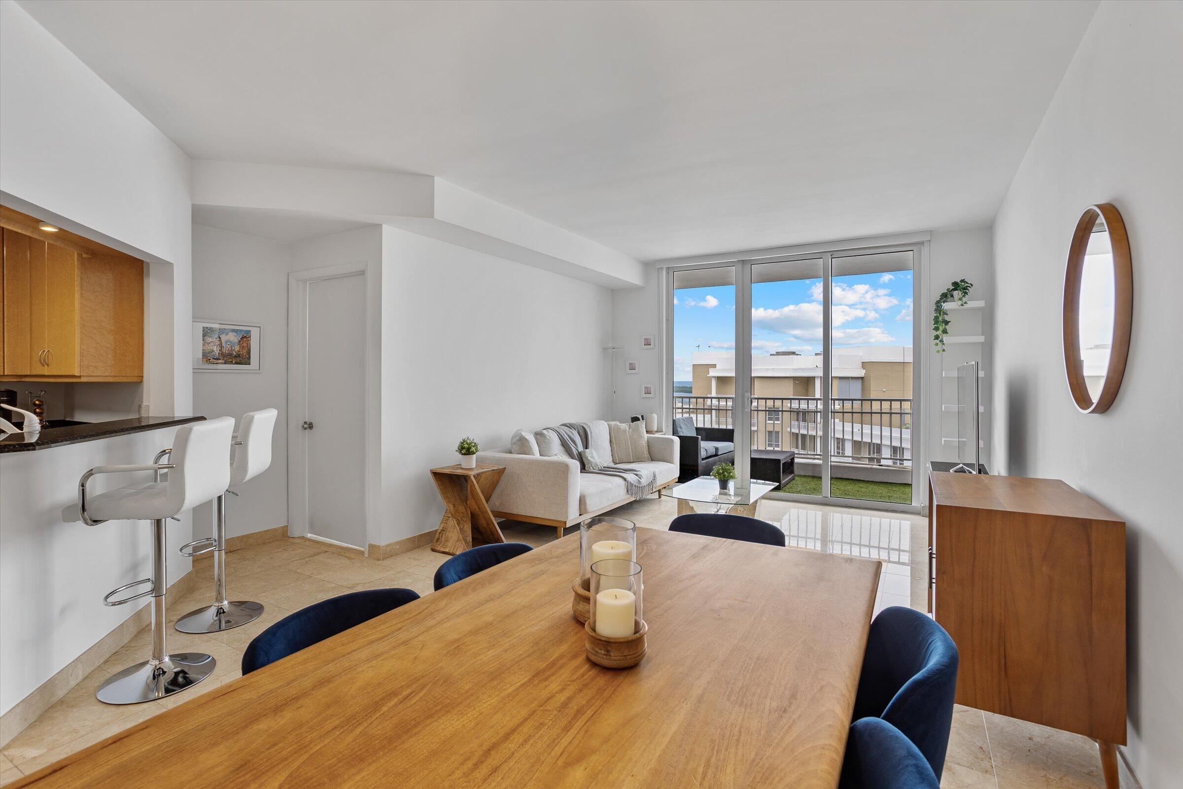 801 Brickell Key Boulevard, Unit 2805 Miami, FL 33131 - Photo 8 of 42 a living room with furniture and a flat screen tv