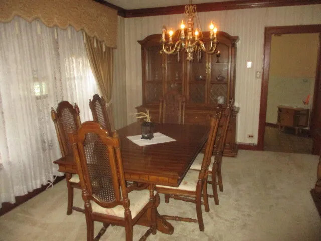 a dining room with furniture and chandelier kitchen view