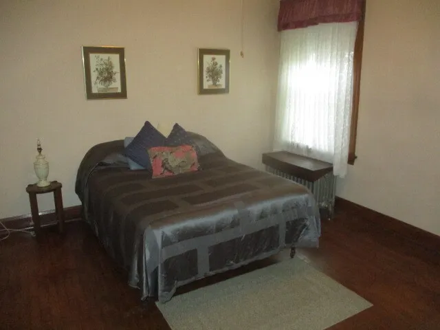 a bed sitting in a bedroom next to a window