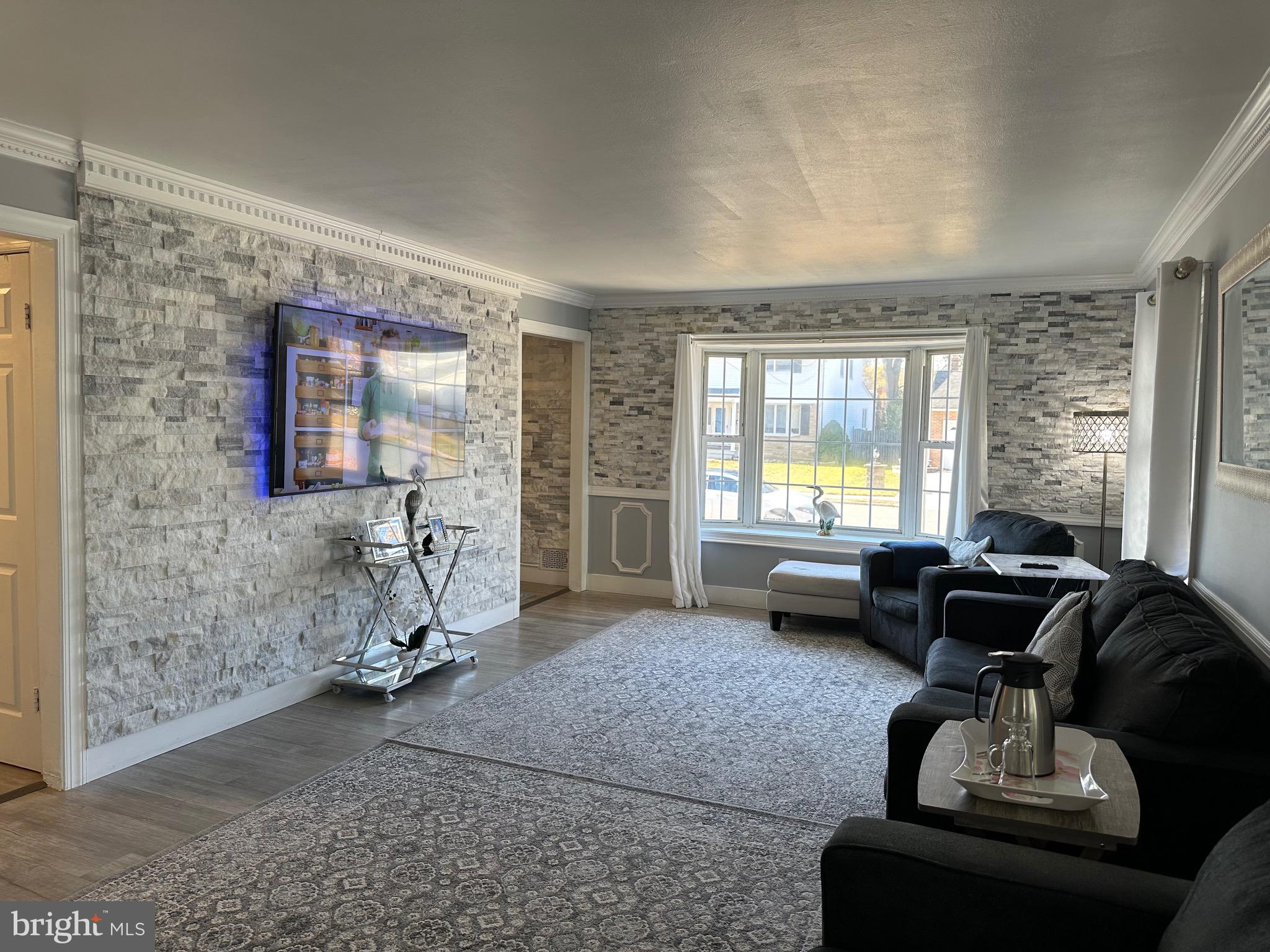 28 Cold Spring Road Hamilton, NJ 08619 - Photo 4 of 34 a living room with furniture and a flat screen tv