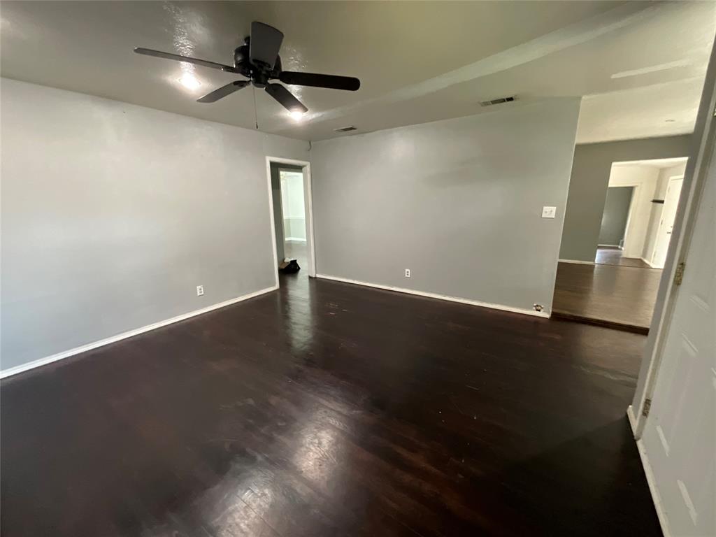 629 Harrison Lane Hurst, TX 76053 - Photo 8 of 20 an empty room with wooden floor and windows