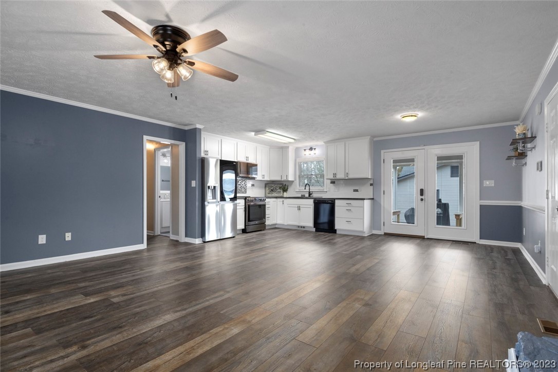 5843 Labonte Drive Hope Mills, NC 28348 - Photo 11 of 43 a view of a kitchen with a microwave and a stove top oven