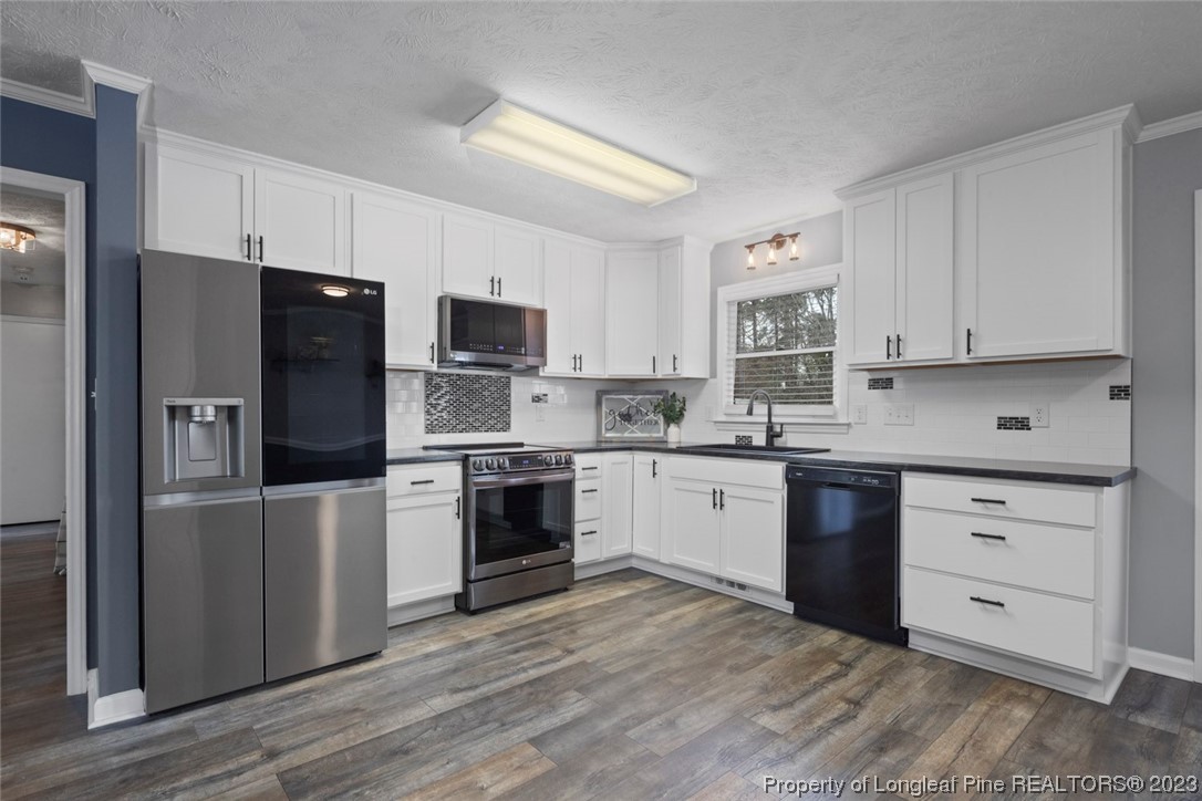 5843 Labonte Drive Hope Mills, NC 28348 - Photo 14 of 43 a kitchen with granite countertop a refrigerator stove and oven