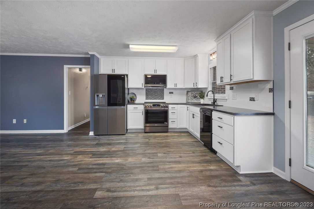 5843 Labonte Drive Hope Mills, NC 28348 - Photo 21 of 43 a large kitchen with cabinets and stainless steel appliances