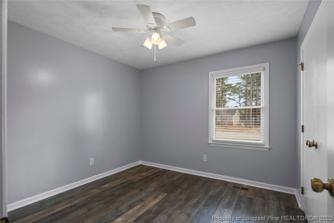 5843 Labonte Drive Hope Mills, NC 28348 - Photo 23 of 43 an empty room with wooden floor and windows