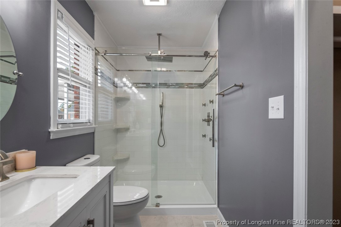 5843 Labonte Drive Hope Mills, NC 28348 - Photo 31 of 43 a bathroom with a sink toilet and shower