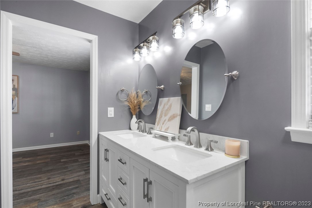 5843 Labonte Drive Hope Mills, NC 28348 - Photo 32 of 43 a bathroom with a double vanity sink and a mirror