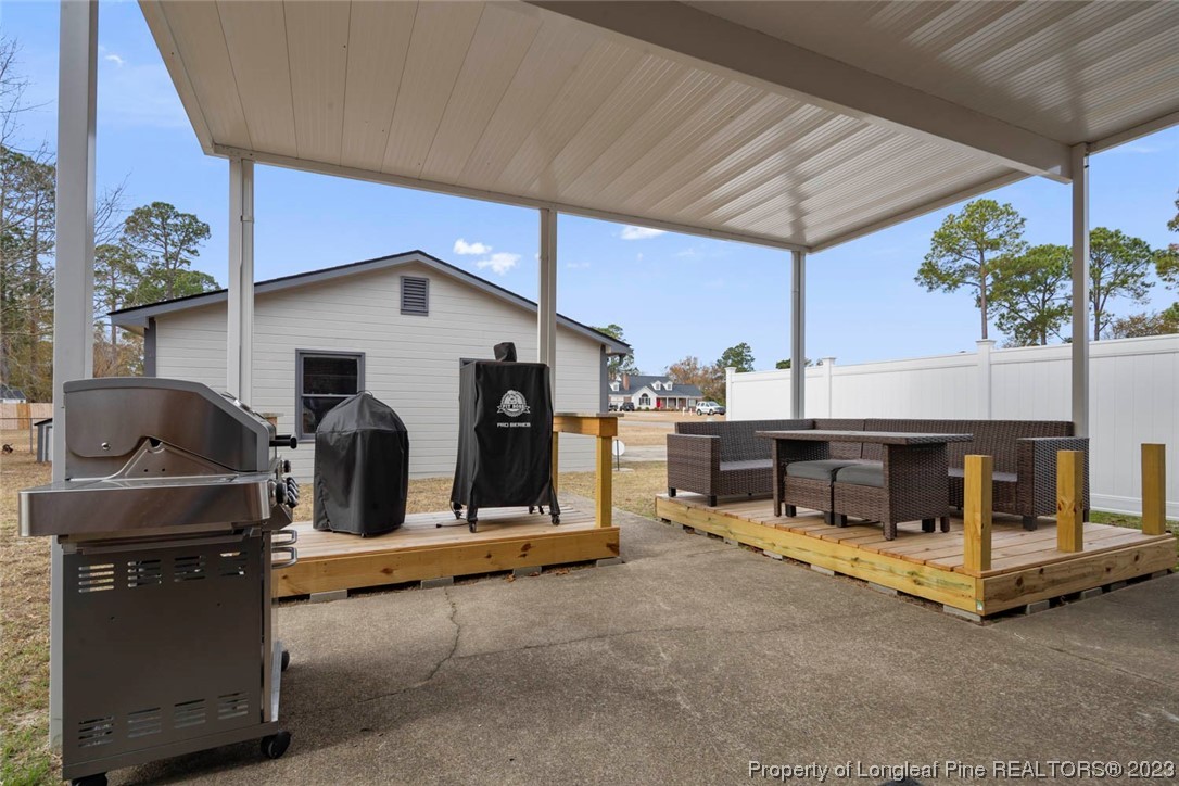 5843 Labonte Drive Hope Mills, NC 28348 - Photo 39 of 43 a view of a patio with table and chairs under an umbrella