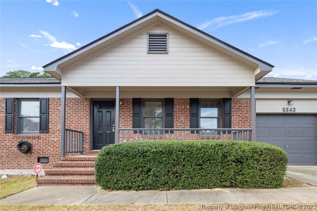 5843 Labonte Drive Hope Mills, NC 28348 - Photo 6 of 43 a front view of a house with a garden