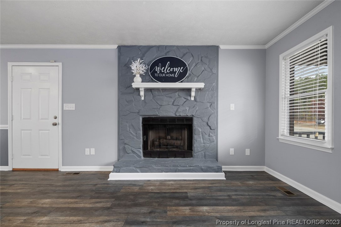 5843 Labonte Drive Hope Mills, NC 28348 - Photo 9 of 43 a living room with a fireplace and a window
