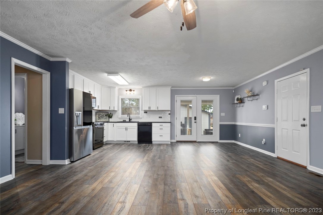 5843 Labonte Drive Hope Mills, NC 28348 - Photo 10 of 43 a large kitchen with cabinets and wooden floor