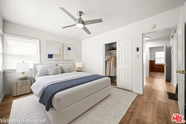 a spacious bedroom with a bed and a chandelier