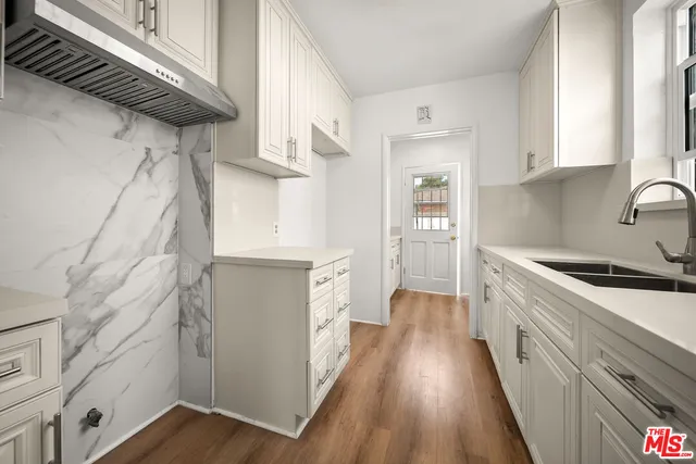 a kitchen with stainless steel appliances granite countertop a stove and a refrigerator