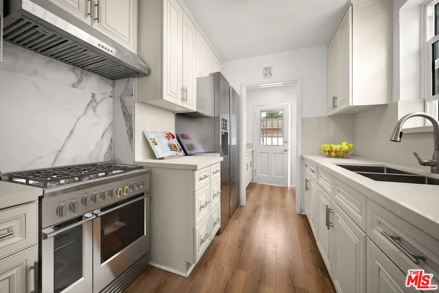 a spacious bedroom with a bed and a chandelier