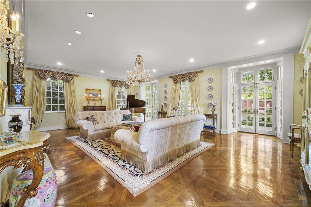 898 Persimmon Road Sewickley, PA 15143 - Photo 9 of 50 The elegant living room is filled with natural light from walls of French doors and large windows overlooking the gardens.