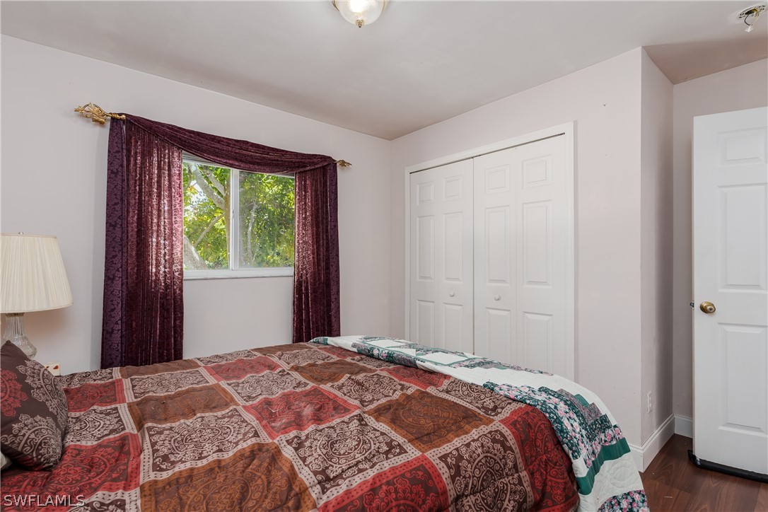 234 Connecticut Road Lehigh Acres, FL 33936 - Photo 14 of 19 a bedroom with a bed and a window