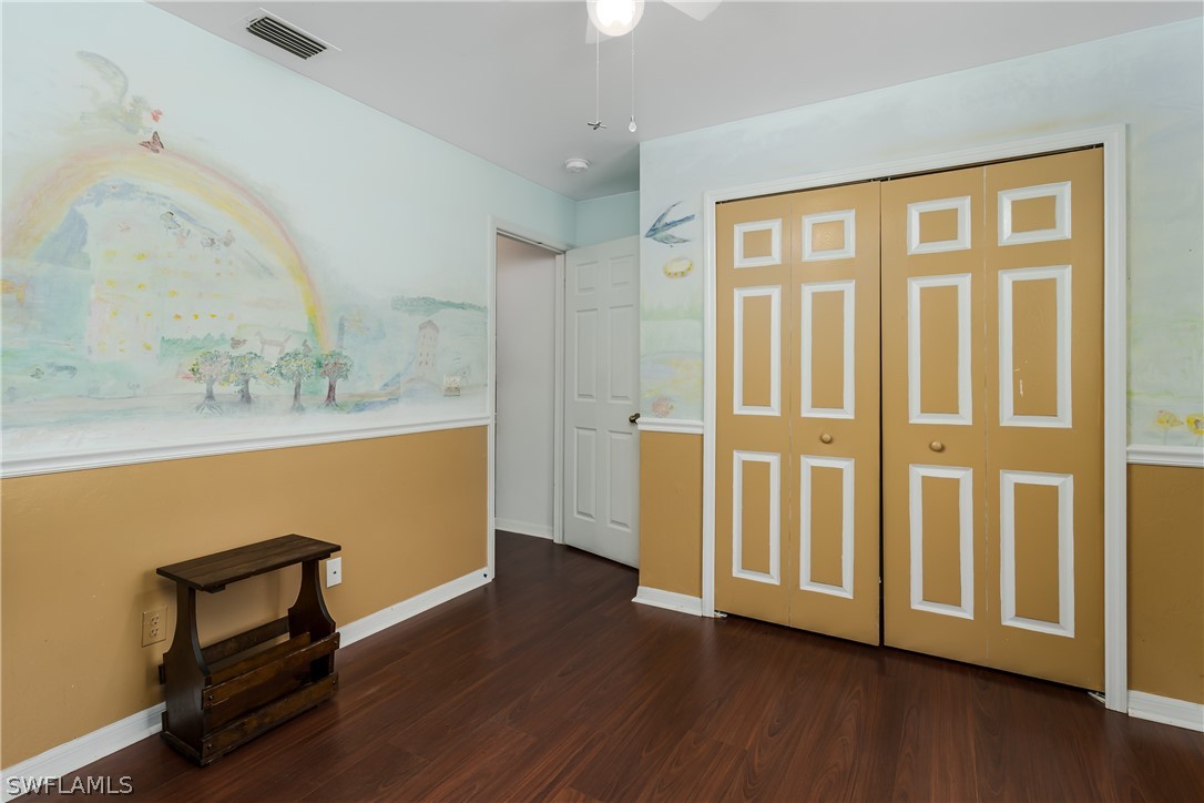 234 Connecticut Road Lehigh Acres, FL 33936 - Photo 17 of 19 a view of an empty room with wooden floor and a window