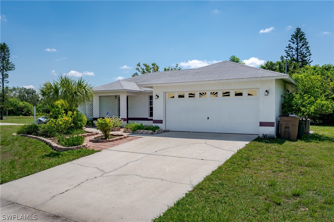 234 Connecticut Road Lehigh Acres, FL 33936 - Photo 2 of 19 a view of a house with a yard