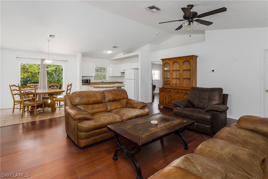 234 Connecticut Road Lehigh Acres, FL 33936 - Photo 6 of 19 a living room with furniture and a wooden floor