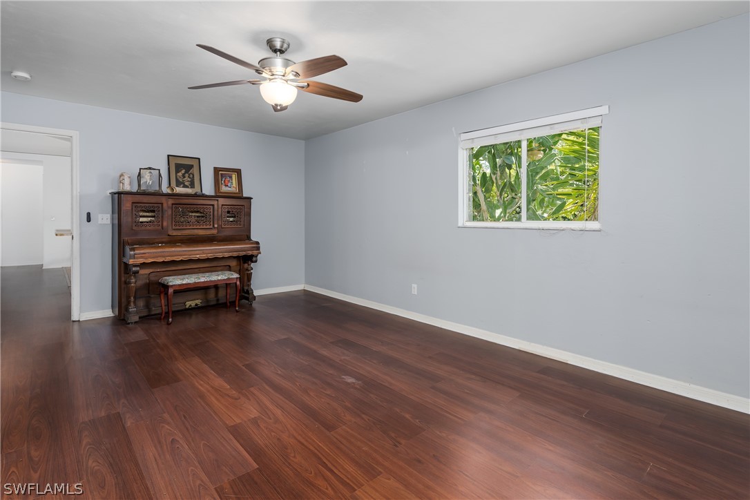 234 Connecticut Road Lehigh Acres, FL 33936 - Photo 10 of 19 a view of livingroom with hardwood floor and a ceiling fan