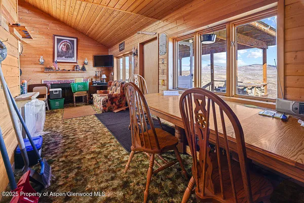 a view of a dining room with furniture window and outside view
