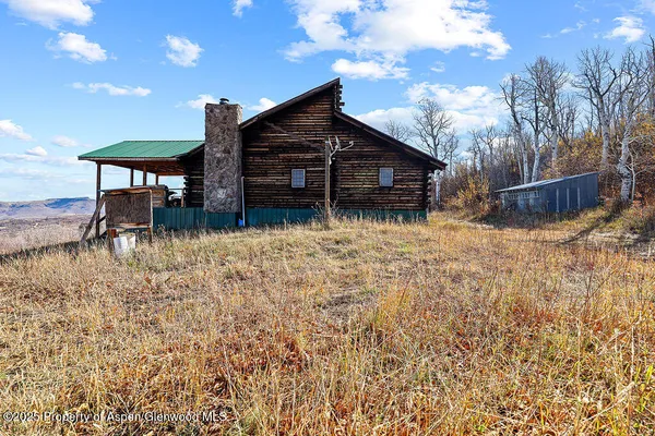 a view of a house with wooden fence