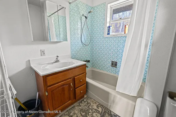 a bathroom with a sink a mirror and a bathtub