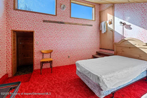 a bed room with a bed and a chair